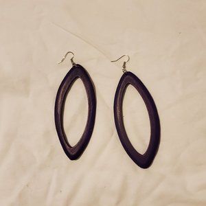 Long drop wood carved purple earrings.